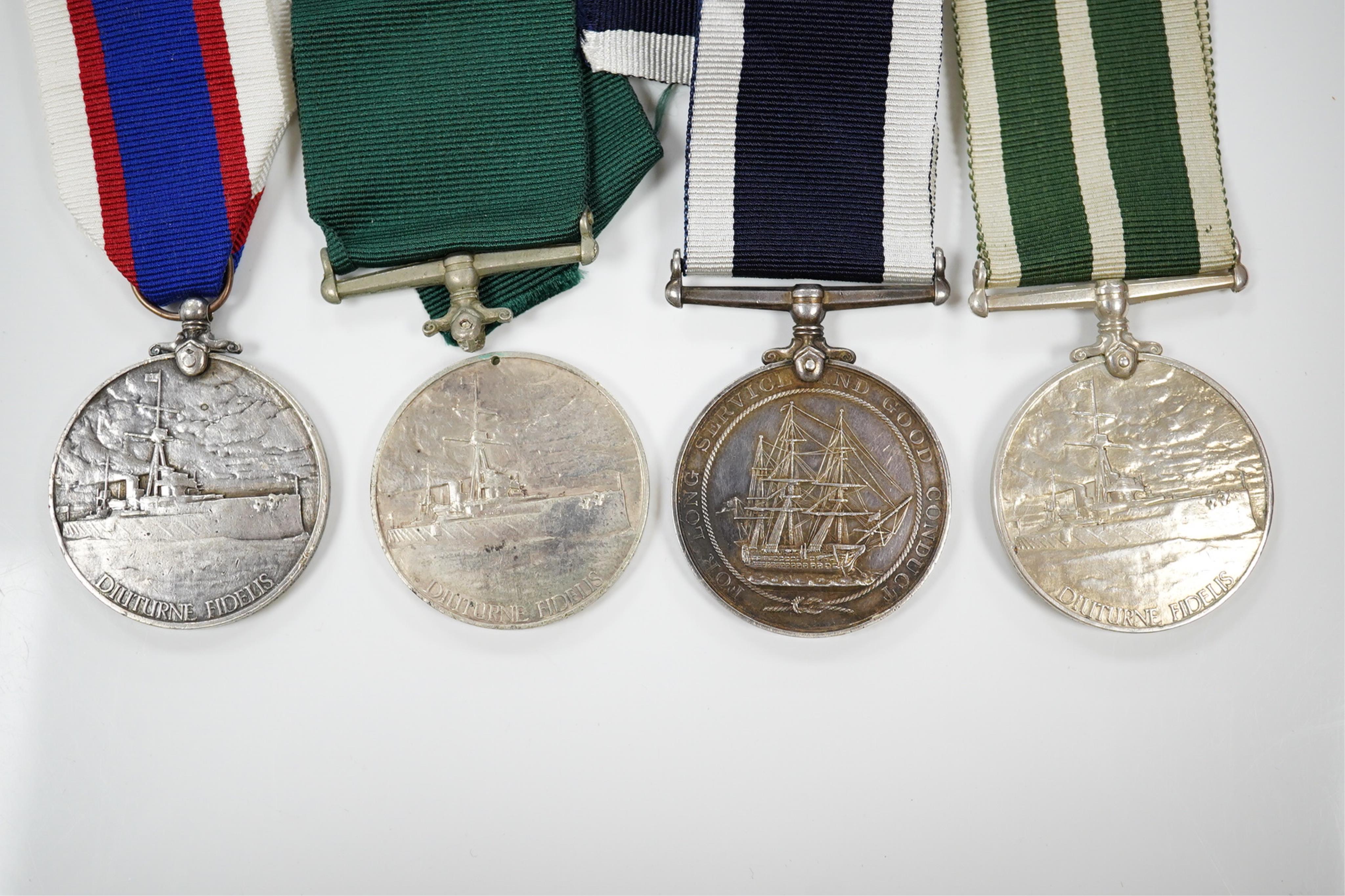 Four assorted Naval service medals; EVII Royal Naval Reserve LSGC to V.440. W.Lewis, STO.RNR.; GV Royal Fleet Reserve LSGC unnamed; GV RNLSGC (renamed) to J,87119 R.S. J.West. A.B.H.M.S.Victory; GV RNRLSGC to 1361V W.H.J